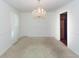 Formal dining room with carpet, chandelier, and doorway to the kitchen at 1561 Montclair St, Charleston, SC 29407