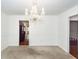 Dining room with wall to wall carpeting and view into kitchen at 1561 Montclair St, Charleston, SC 29407