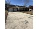 Charming single story brick home featuring an attached two car garage and large concrete driveway at 1561 Montclair St, Charleston, SC 29407