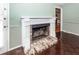 Close-up of the living room fireplace with decorative white mantle and brick hearth at 1561 Montclair St, Charleston, SC 29407