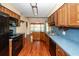 Eat in kitchen with wood cabinets, wood floors, black appliances and an eat at bar at 1561 Montclair St, Charleston, SC 29407