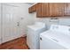 Convenient laundry room with washer, dryer, and storage cabinets at 1561 Montclair St, Charleston, SC 29407