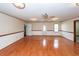 Living room with hardwood floors, wainscoting, a ceiling fan, and three doors at 1561 Montclair St, Charleston, SC 29407