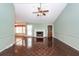 Spacious living room with vaulted ceilings, ceiling fan, and brick fireplace with white mantle at 1561 Montclair St, Charleston, SC 29407