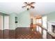 Bright living room featuring hardwood floors, fireplace, and ceiling fan at 1561 Montclair St, Charleston, SC 29407