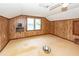 Room in need of repair featuring a ceiling fan, wood paneled walls and water damage at 1561 Montclair St, Charleston, SC 29407