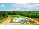 Aerial view of a pool and amenity center surrounded by lush greenery and landscaping in a beautiful community at 158 Yarrow Way, Moncks Corner, SC 29461