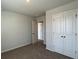 A cozy bedroom featuring neutral walls, plush carpeting, and a double door closet for optimal storage at 158 Yarrow Way, Moncks Corner, SC 29461