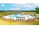 An inviting community pool with a pergola, sun loungers, and clear blue water under a partly cloudy sky at 158 Yarrow Way, Moncks Corner, SC 29461