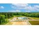 Community outdoor pool area with playground, pond, and landscaping at 166 Yarrow Way, Moncks Corner, SC 29461