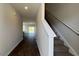 Bright hallway leads to living area with wood floors and view to outside through sliding glass doors at 166 Yarrow Way, Moncks Corner, SC 29461