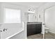 Bathroom featuring a soaking tub and a dark vanity, offering a serene space for relaxation at 180 Basket Grass Ln, Summerville, SC 29486