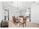 Spacious dining room features a tray ceiling, classic chandelier, and flows into adjacent living spaces, ideal for entertaining at 180 Basket Grass Ln, Summerville, SC 29486