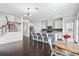 Open-concept kitchen and dining area with white cabinets, granite countertops, stainless steel appliances, and hardwood floors at 180 Basket Grass Ln, Summerville, SC 29486