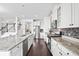Stylish kitchen with white cabinetry, granite countertops, stainless steel appliances, and mosaic tile backsplash at 180 Basket Grass Ln, Summerville, SC 29486
