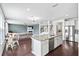 Open-concept kitchen with stainless steel appliances, island seating, view to living room, and adjacent dining area at 180 Basket Grass Ln, Summerville, SC 29486