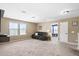 Expansive living room with plush carpeting, recessed lighting and a comfortable seating area at 180 Basket Grass Ln, Summerville, SC 29486