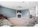 Expansive living room with a fireplace, TV, neutral carpet, ceiling fan, and comfortable sectional sofa seating at 180 Basket Grass Ln, Summerville, SC 29486