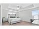 Bright main bedroom featuring neutral decor, a ceiling fan, and large windows, creating a relaxing space at 180 Basket Grass Ln, Summerville, SC 29486