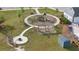 Aerial view of a community playground featuring a fire pit, swings, and a pool at 180 Basket Grass Ln, Summerville, SC 29486