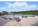 A community pool with seating area, splash pad, and surrounding trees at 180 Basket Grass Ln, Summerville, SC 29486