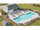 Aerial view of a neighborhood pool with a splash pad, surrounding lounge chairs, and covered pavilion at 180 Basket Grass Ln, Summerville, SC 29486