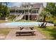 Inviting backyard with a sparkling pool, lounge chairs, and a charming picnic table at 187 Pecan Dr, Summerville, SC 29483