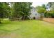 Spacious backyard with lush green grass, mature trees, and a wooden fence surrounding the property at 187 Pecan Dr, Summerville, SC 29483