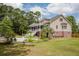 Expansive backyard features a swimming pool and a well-manicured lawn with mature trees at 187 Pecan Dr, Summerville, SC 29483