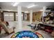 A large finished basement with white columns, two garage doors, and a colorful rug at 187 Pecan Dr, Summerville, SC 29483