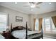 Traditional bedroom boasts a four-poster bed, neutral walls, and plenty of natural light from large windows at 187 Pecan Dr, Summerville, SC 29483