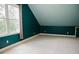Bonus room with carpet, a window, teal walls, and white trim at 187 Pecan Dr, Summerville, SC 29483
