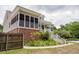 Beautiful home with a spacious screened porch, white railings, and landscaped garden area at 187 Pecan Dr, Summerville, SC 29483