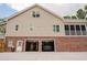 Two-story tan home with a brick foundation and two-car garage showcasing a vehicle parked inside at 187 Pecan Dr, Summerville, SC 29483