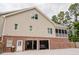Tan two-story house with brick foundation, featuring a two-car garage with a vehicle inside at 187 Pecan Dr, Summerville, SC 29483