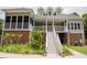 Charming two-story home featuring brick accents, white railings, and lush landscaping at 187 Pecan Dr, Summerville, SC 29483