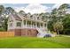 Attractive home with a classic design, prominent front porch, and verdant green lawn at 187 Pecan Dr, Summerville, SC 29483