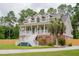 Beautiful home featuring a welcoming front porch, lush lawn, and mature landscaping at 187 Pecan Dr, Summerville, SC 29483