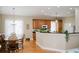 Open kitchen and dining area with natural wood cabinets and black countertops at 187 Pecan Dr, Summerville, SC 29483