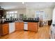 Well-equipped kitchen adjacent to the dining area with natural wood cabinetry and hardware flooring at 187 Pecan Dr, Summerville, SC 29483