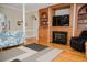 Cozy living room with fireplace, custom built-ins, hardwood floors, and large columns at 187 Pecan Dr, Summerville, SC 29483