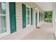 Inviting covered porch with green shutters and ample space for outdoor seating and relaxation at 187 Pecan Dr, Summerville, SC 29483