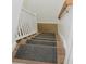 Carpeted steps on a light-colored wood staircase and white railings at 187 Pecan Dr, Summerville, SC 29483