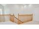A wooden staircase featuring wood railings and light-colored carpeting at 187 Pecan Dr, Summerville, SC 29483