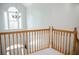 Wooden railing looking out over the front door, chandelier, and large arched window at 187 Pecan Dr, Summerville, SC 29483
