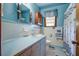 Vintage bathroom with blue fixtures, a shower-tub combo, and a classic tiled floor at 1925 Belgrade Ave, Charleston, SC 29407