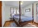 Bedroom featuring a four-poster bed, wood floors, and large window with natural light at 1925 Belgrade Ave, Charleston, SC 29407