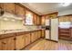 Well-lit kitchen featuring warm wood cabinets, modern appliances, and a cozy, vintage design at 1925 Belgrade Ave, Charleston, SC 29407