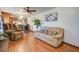 Cozy living room featuring plush seating, wood floors, and an open layout connecting to the kitchen and dining area at 1925 Belgrade Ave, Charleston, SC 29407