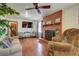 Comfortable living room with a brick fireplace, ceiling fan, and a large television for entertainment at 1925 Belgrade Ave, Charleston, SC 29407